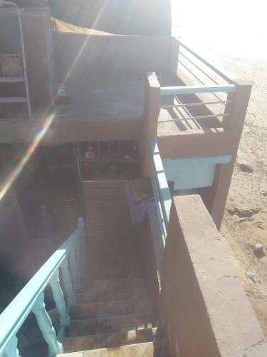 a set of stairs leading down to the beach at Grotte de pêcheurs RITAJ, Aglou in Tiznit