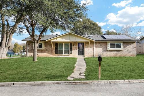 a brick house with a parking meter in the grass at Centrally Located Little Gem in San Antonio