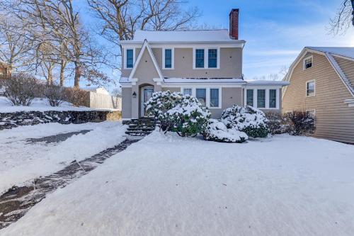 a white house with snow on the driveway at Charming Connecticut Retreat Near Museums and Hiking in Waterbury