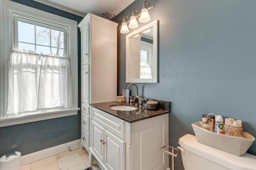 a bathroom with a sink and a mirror and a toilet at Charming Connecticut Retreat Near Museums and Hiking in Waterbury
