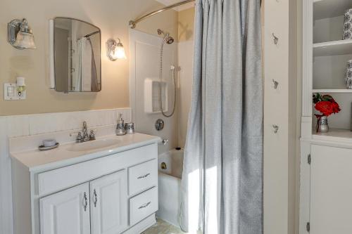 a white bathroom with a sink and a shower at Charming Connecticut Retreat Near Museums and Hiking in Waterbury