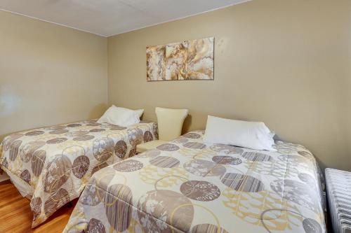 a room with two beds and a picture on the wall at Charming Connecticut Retreat Near Museums and Hiking in Waterbury