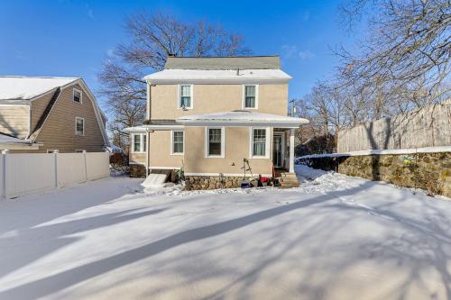 a house in the snow with a fence at Charming Connecticut Retreat Near Museums and Hiking in Waterbury