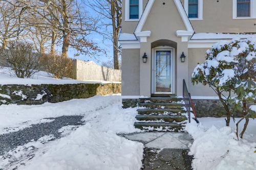 a white house with snow on the ground at Charming Connecticut Retreat Near Museums and Hiking in Waterbury