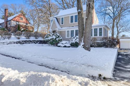a white house with snow on the driveway at Charming Connecticut Retreat Near Museums and Hiking in Waterbury