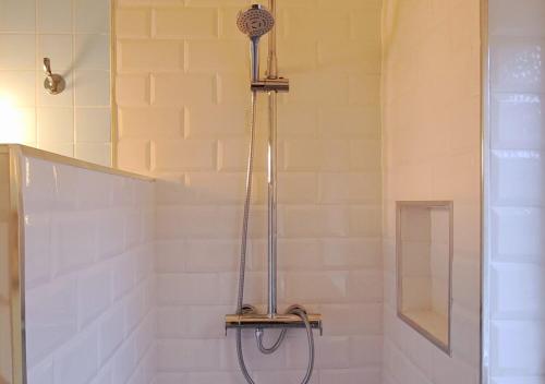 a shower with a shower head in a bathroom at El Chalet de los molinos in Los Molinos