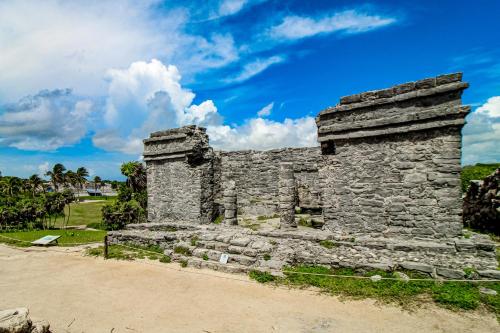 an old stone building on the side of a road at Miraluna 233 at Luum Zama in Tulum