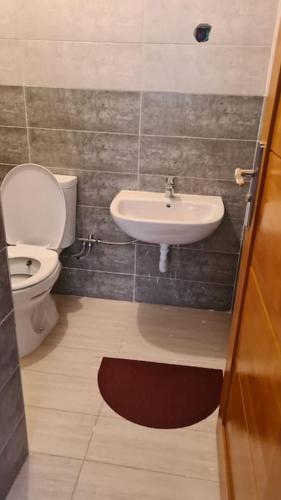 a bathroom with a toilet and a sink at Rooms in shared apartment close to CMN-Airport in Dah Hammou Ben Cheïkh