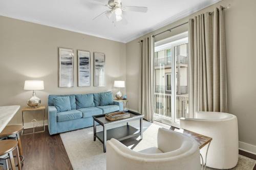a living room with a blue couch and a table at The Nautilus in Gulf Shores