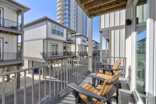 two chairs sitting on the balcony of a building at The Nautilus in Gulf Shores