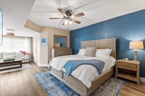 a bedroom with a bed and a ceiling fan at Oceanwalk 1-401 in New Smyrna Beach