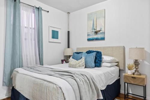a bedroom with a large bed with blue pillows at 1BR Apt Walk to Central Park and Columbia University in New York