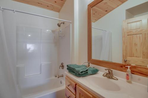 a bathroom with a sink and a shower and a mirror at Hines Vacation Rental with Grill Walk to Lake! 