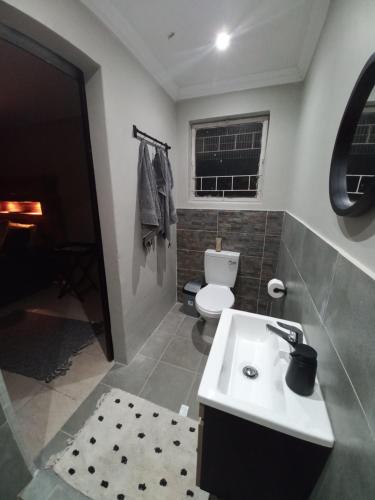 a bathroom with a white sink and a toilet at 284 on circular in Sunridge Park