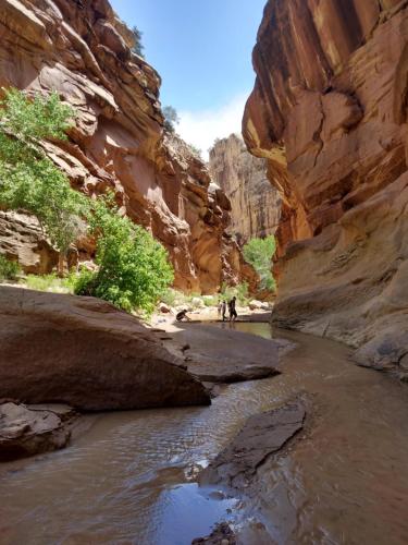 two people walking through a river in a canyon at Bryce Canyon Villas in Cannonville