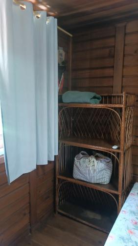 a room with wooden walls and a room at Pousada Sobre as Ondas - ILHA DO MEL - PR in Ilha do Mel