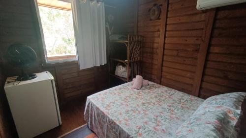 a bedroom with a bed with a box on it at Pousada Sobre as Ondas - ILHA DO MEL - PR in Ilha do Mel