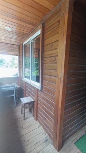 a wooden cabin with a bench and a window at Pousada Sobre as Ondas - ILHA DO MEL - PR in Ilha do Mel