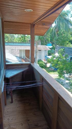 an empty porch of a house with a window at Pousada Sobre as Ondas - ILHA DO MEL - PR in Ilha do Mel