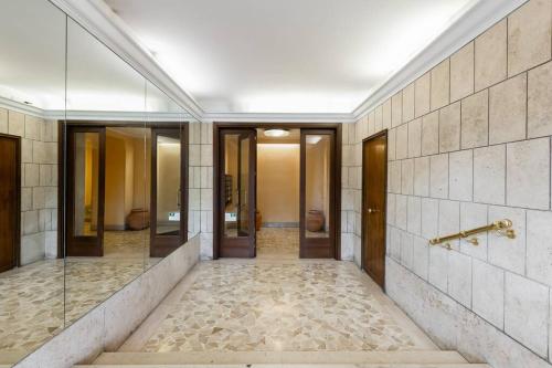 a hallway with glass doors and a walk in shower at Domus In Roma Suite in Rome