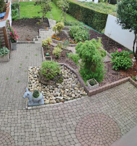 a garden with a stone pathway with plants and flowers at Haus Steinmeyer in Bad Pyrmont