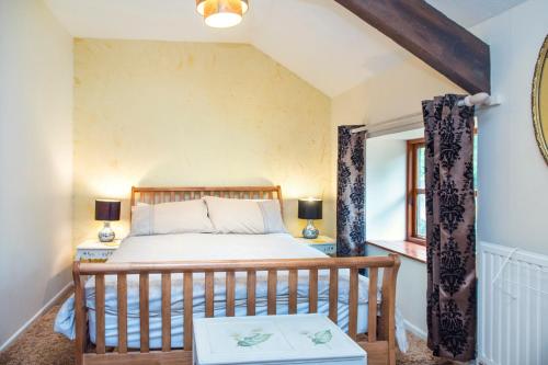 En eller flere senge i et værelse på Mill Cottage - Great Houndbeare Farm Holiday Cottages