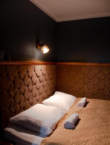 a bedroom with a bed with two towels on it at Marókahegy in Zalakaros
