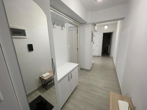 a hallway of a room with white walls and a white counter at Traveler’s Luxury Home in Suceava