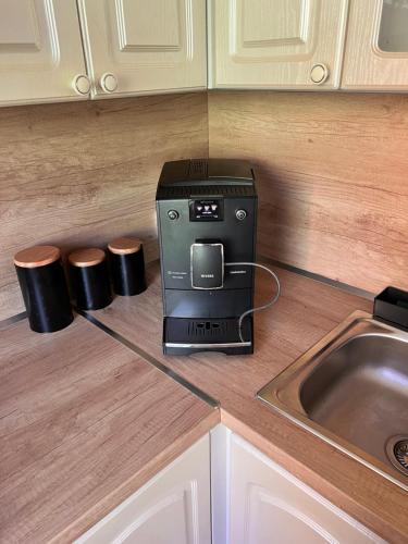 a coffee maker on a counter next to a sink at Ubytování Na Jarošce in Hodonín