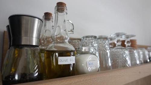 a shelf with several bottles and glasses on it at Kuća za odmor Sedra in Hrvatska Kostajnica