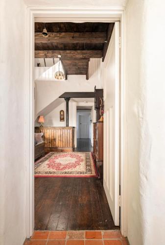 an open hallway leading into a room with a rug at Rosehill House in Dungannon