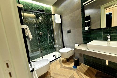 a bathroom with a sink and a toilet and a shower at In Costa Relais & Luxury Suites in Vietri sul Mare