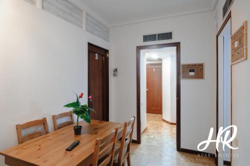 a dining room with a wooden table and chairs at HR-Madrid-Puerta del Sol in Madrid