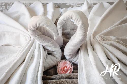 a pink rose in the middle of white sheets at HR-Madrid-Puerta del Sol in Madrid