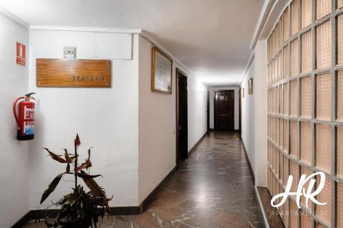 a hallway with a fire extinguisher on the wall at HR-Madrid-Puerta del Sol in Madrid
