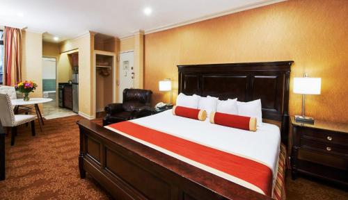 a hotel room with a large bed and a desk at Radio City Apartments in New York