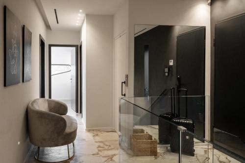 a living room with a chair and a mirror at Meltemi Villas Crete in Heraklio Town