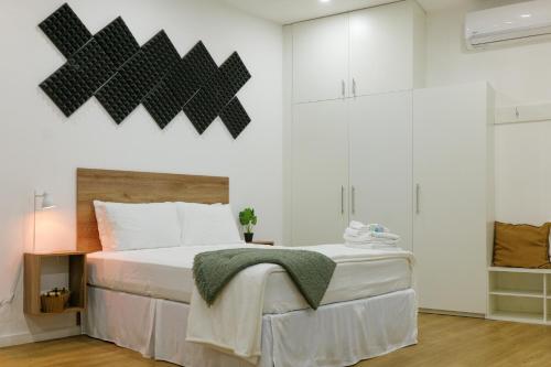 a bedroom with a large bed and white walls at Casa Valencia 1 in Santa Elena