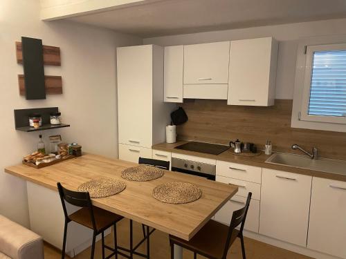 a kitchen with a wooden table and some chairs at Casina Cesena in Cesena