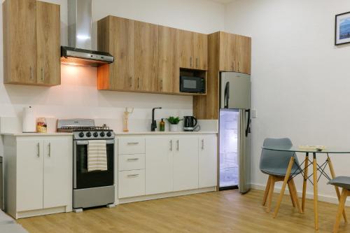 a kitchen with white cabinets and a stove at Casa Valencia 1 in Santa Elena