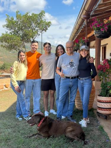 a group of people posing for a picture with a dog at Hotel Palais Barichara in Barichara