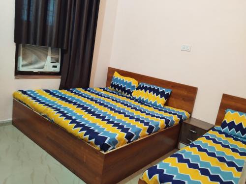 a bedroom with two beds and a window at Shiv Shakti Palace in Rīngas