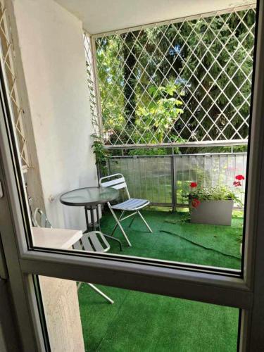 a view from a window of a patio with a table and chairs at Great Apart Imielin in Warsaw