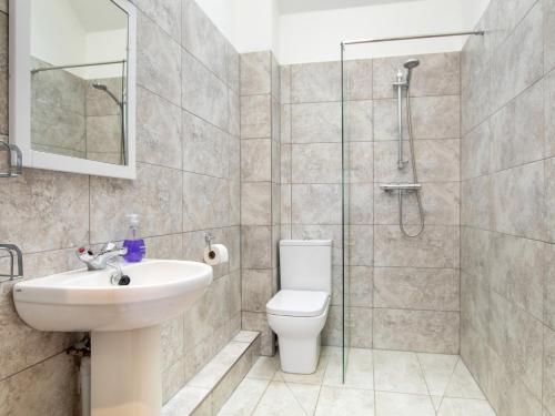 a bathroom with a toilet and a sink and a shower at 2 bed in Bath 72836 in Chew Magna