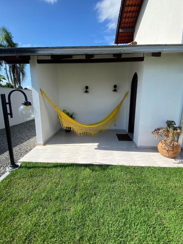 a hammock hanging on the side of a house at RCM Vilas - Casa Confortável 02 in Joinville