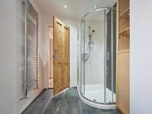 a bathroom with a shower and a glass door at 2 Bed in Cockermouth SZ282 in Cockermouth
