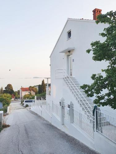 a white building with stairs on the side of a road at Aurora Seaview Apartment in Mlini