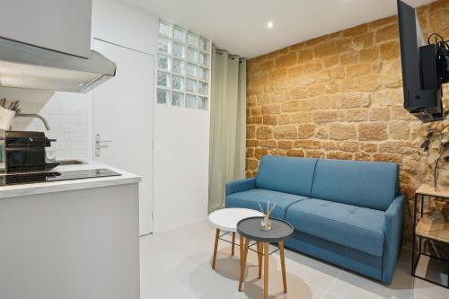 巴黎的住宿－Tiny Suite 12 D Paris’s heart!，客厅配有蓝色的沙发和桌子