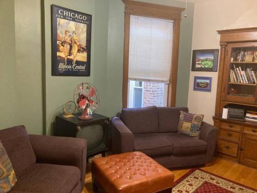 a living room with a couch and a chair at Private room with full size bed in Lakeview - 3c in Chicago