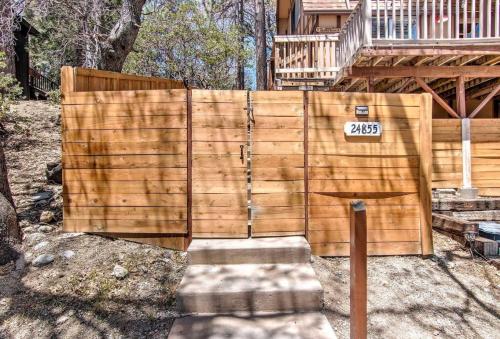 a wooden fence in front of a house at Blissfully Wild -with Hot Tub and pets are welcome in Idyllwild